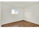 Clean and simple bedroom features a single window and wood flooring at 10211 Ura_ Ln # 101, Thornton, CO 80260