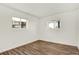 Clean and simple bedroom features a large window and wood flooring at 10211 Ura_ Ln # 101, Thornton, CO 80260