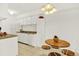 Well-lit kitchen with white cabinets, modern appliances, and a cozy dining area with seating for four at 10211 Ura_ Ln # 101, Thornton, CO 80260