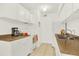 Cozy kitchen with white cabinets, modern appliances, and an adjacent dining area at 10211 Ura_ Ln # 101, Thornton, CO 80260