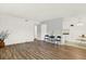 Bright living room features wood floors, white walls, and natural light at 10211 Ura_ Ln # 101, Thornton, CO 80260