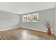 Spacious living room featuring hardwood floors, large windows, and minimalist décor at 10211 Ura_ Ln # 101, Thornton, CO 80260
