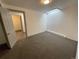 Finished basement room with grey carpet and access to another room at 4445 Milwaukee St, Denver, CO 80216