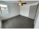 Spacious bedroom with grey wood floors and ceiling fan at 4445 Milwaukee St, Denver, CO 80216