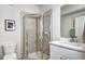 Modern bathroom featuring glass-enclosed shower, tiled walls, and a white vanity at 852 Kalamath St, Denver, CO 80204