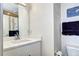Clean, bright bathroom featuring a white vanity, large mirror, and minimalist decor at 852 Kalamath St, Denver, CO 80204