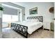 Bright bedroom features a stylish black metal bed frame, a large window, and neutral decor at 852 Kalamath St, Denver, CO 80204