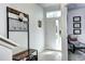 Welcoming entryway with a stylish bench, coat rack, and tiled flooring at 852 Kalamath St, Denver, CO 80204