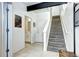 Bright entryway with tiled floors, staircase, and adjacent bathroom with a white vanity at 852 Kalamath St, Denver, CO 80204