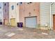 Back exterior view of colorful row houses with garage doors at 852 Kalamath St, Denver, CO 80204