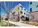 Contemporary townhouse exterior with a mix of colorful siding and brick accents and landscaped grounds at 852 Kalamath St, Denver, CO 80204
