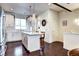 Bright, open kitchen with an island, stainless steel appliances, white cabinets, and hardwood floors at 852 Kalamath St, Denver, CO 80204