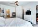 Main bedroom with a walk-in closet, adjacent bathroom, a ceiling fan, and modern decor at 852 Kalamath St, Denver, CO 80204