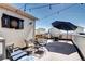 Rooftop deck with outdoor seating, dart board, and string lights for a perfect city escape at 852 Kalamath St, Denver, CO 80204