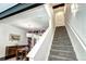 Staircase next to a modern dining area featuring a wood credenza and colorful geometric wall art at 852 Kalamath St, Denver, CO 80204