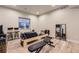 The spacious basement features exercise equipment and bright recessed lighting at 6211 Stable View St, Castle Pines, CO 80108