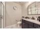Stylish bathroom featuring a walk-in shower, modern vanity, and a unique decorative mirror at 6211 Stable View St, Castle Pines, CO 80108