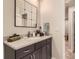 Well-lit bathroom with a granite countertop vanity, a large mirror, and modern fixtures at 6211 Stable View St, Castle Pines, CO 80108