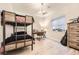 Comfortable bedroom with bunk beds, a wooden desk, and natural light from a large window at 6211 Stable View St, Castle Pines, CO 80108