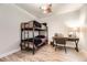 Comfortable bedroom with bunk beds, a wooden desk, and natural light from a large window at 6211 Stable View St, Castle Pines, CO 80108
