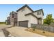 Charming two-story home with a two car garage, modern fence, and manicured yard at 6211 Stable View St, Castle Pines, CO 80108