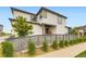 Charming two-story home with a covered patio, a modern fence, and lovely landscaping at 6211 Stable View St, Castle Pines, CO 80108