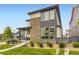Attractive home with a stone-clad exterior, covered porch, and professionally landscaped front yard at 6211 Stable View St, Castle Pines, CO 80108