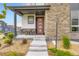 Welcoming porch features stylish seating and a clear view of the home's unique front door at 6211 Stable View St, Castle Pines, CO 80108