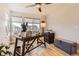 Well-lit home office with a ceiling fan, modern desk, storage chest and neighborhood views at 6211 Stable View St, Castle Pines, CO 80108