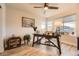Bright home office with modern desk, ceiling fan, and large windows offering plenty of natural light at 6211 Stable View St, Castle Pines, CO 80108
