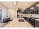 Kitchen island with marbled countertop and navy cabinets plus stainless steel appliances at 6211 Stable View St, Castle Pines, CO 80108