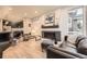 Cozy living room with a fireplace, hardwood floors, and modern furnishings at 6211 Stable View St, Castle Pines, CO 80108