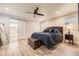 Main bedroom with ceiling fan and ensuite bathroom behind sliding barn door at 6211 Stable View St, Castle Pines, CO 80108