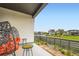 Relaxing patio with hanging chairs, side tables, and a view of the neighborhood at 6211 Stable View St, Castle Pines, CO 80108