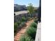 Landscaped side yard featuring rock and grass, wood pavers, and modern fence at 6211 Stable View St, Castle Pines, CO 80108