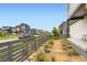 Serene side yard featuring a modern fence, rock landscaping, and a paver walkway at 6211 Stable View St, Castle Pines, CO 80108