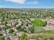 Aerial view of a neighborhood with mature trees and green spaces at 17051 Wellington Dr, Parker, CO 80134