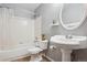 Bathroom with tiled shower and pedestal sink with neutral colored walls at 17051 Wellington Dr, Parker, CO 80134