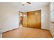 Bright bedroom featuring wood floors, a ceiling fan, and a spacious closet with sliding doors at 17051 Wellington Dr, Parker, CO 80134