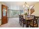Elegant dining room featuring a dark wood table, upholstered chairs, and abundant natural light at 17051 Wellington Dr, Parker, CO 80134