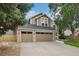 Charming two-story home with a well-maintained lawn, mature trees, and a three-car garage at 17051 Wellington Dr, Parker, CO 80134