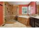Luxurious main bathroom featuring a glass-enclosed shower, soaking tub, and elegant tile work at 17051 Wellington Dr, Parker, CO 80134
