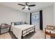 A cozy bedroom with plush carpet, ceiling fan and a window with black curtains at 1793 E 164Th Pl, Brighton, CO 80602