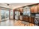 Well-lit kitchen featuring stainless steel appliances, granite countertops, and dark wood cabinetry at 1793 E 164Th Pl, Brighton, CO 80602