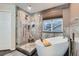 Modern bathroom featuring a soaking tub, glass shower, and elegant tile work at 1793 E 164Th Pl, Brighton, CO 80602