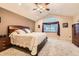 Vaulted ceiling bedroom with large window, plush carpet, and a ceiling fan at 1793 E 164Th Pl, Brighton, CO 80602