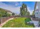 Spacious backyard with lush green grass and mature trees, perfect for outdoor activities at 1793 E 164Th Pl, Thornton, CO 80602