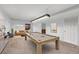 Finished basement featuring a pool table and comfortable seating area at 1793 E 164Th Pl, Thornton, CO 80602