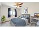 Comfortable bedroom with a plush bed, blue accents, and a ceiling fan at 1793 E 164Th Pl, Thornton, CO 80602