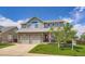 Charming two-story home featuring a stone facade, manicured lawn, and a two-car garage at 1793 E 164Th Pl, Thornton, CO 80602